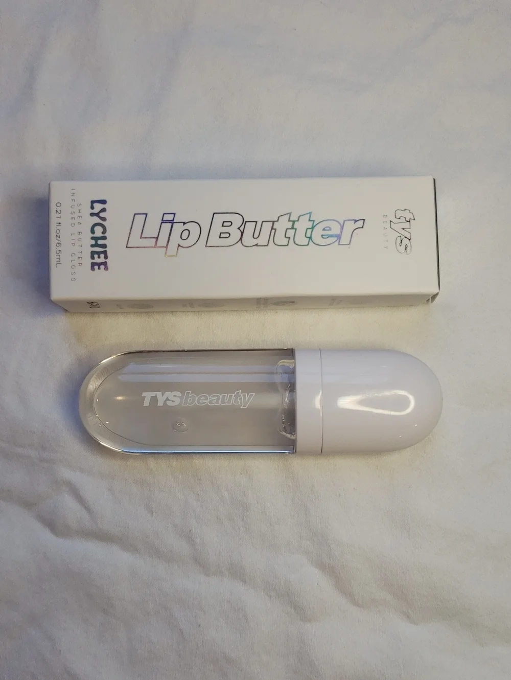Lychee scented clear shea butter lip gloss.  TYS Beauty brand